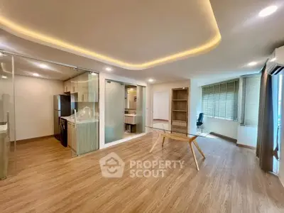 Spacious modern living room with open kitchen and stylish lighting