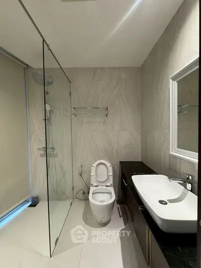 Modern bathroom with glass shower and sleek fixtures