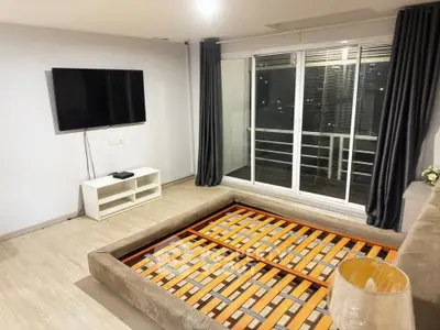 Spacious living room with modern decor and large window for natural light.