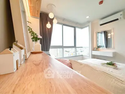 Bright and modern bedroom with large windows and city view, featuring stylish decor and cozy ambiance.
