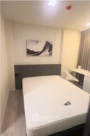 Modern bedroom with stylish decor and comfortable bed in a contemporary apartment.