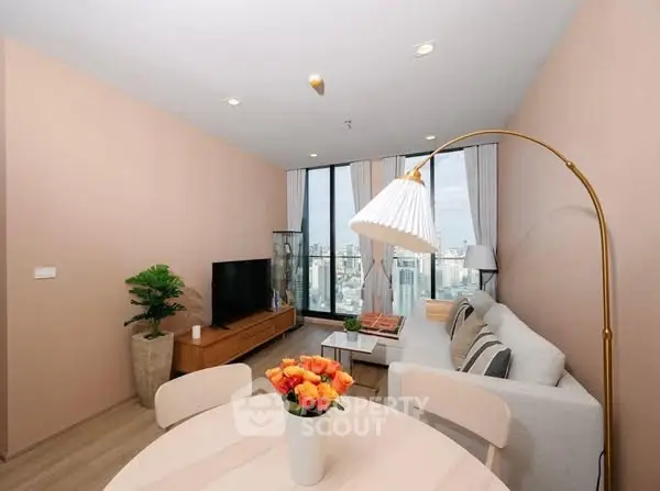 Modern living room with city view, stylish decor, and cozy ambiance.