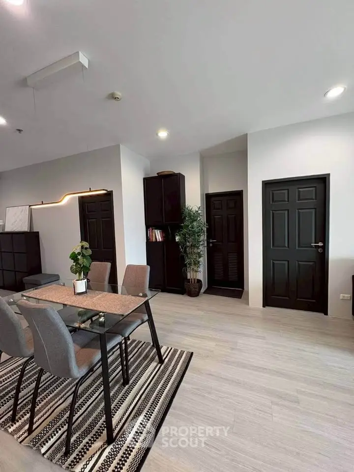 Modern dining area with sleek furniture and stylish decor in a contemporary apartment.