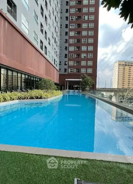 Luxurious high-rise building with stunning poolside view and modern amenities.