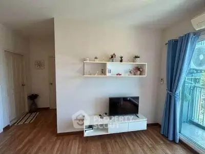 Charming living room with modern decor and balcony access, perfect for relaxation and entertainment.