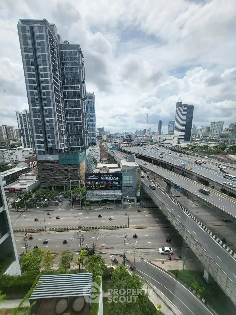 Stunning urban view from high-rise building overlooking city skyline and highway.