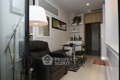 Modern living room with sleek black leather chair and stylish dining area