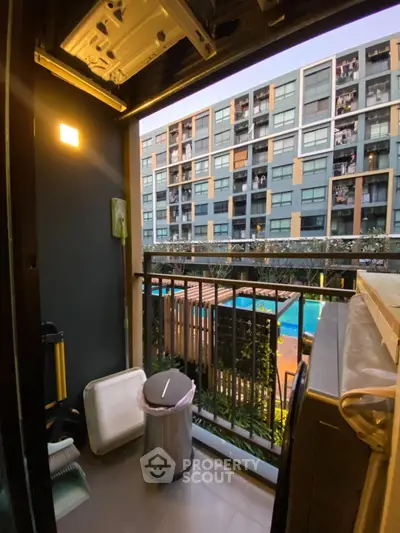 Modern apartment balcony with pool view and urban landscape
