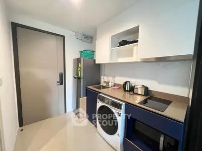 Modern compact kitchen with appliances and sleek cabinetry