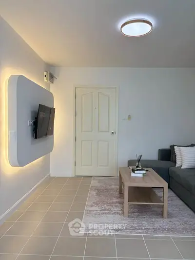 Modern living room with sleek TV setup and cozy seating area