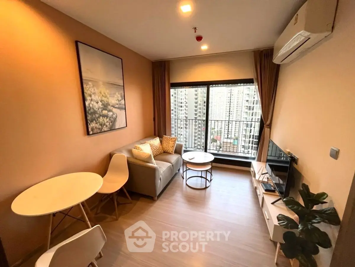 Modern living room with city view, cozy seating, and stylish decor in high-rise apartment.