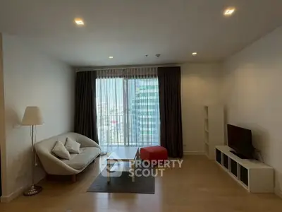 Spacious living room with modern furniture and city view, perfect for urban living.