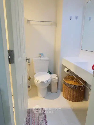 Modern bathroom with sleek fixtures and ample storage space.