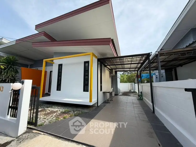 Modern single-story house with unique architectural design and spacious driveway