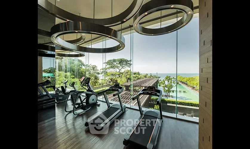 Luxurious gym with ocean view and modern equipment in high-end real estate property.