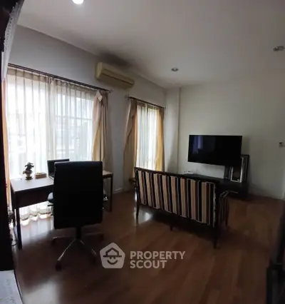 Spacious living room with modern furniture and large windows for natural light.