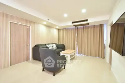 Spacious living room with modern furniture and elegant lighting