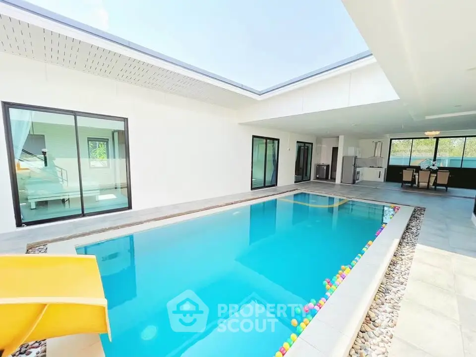 Luxurious modern villa with private indoor pool and open kitchen layout, perfect for relaxation and entertainment.