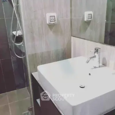 Modern bathroom with sleek sink and glass shower enclosure