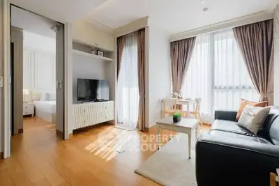 Bright and cozy living room with wooden flooring and modern furnishings in a stylish apartment.