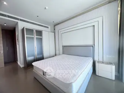 Spacious modern bedroom with sleek design and ample natural light