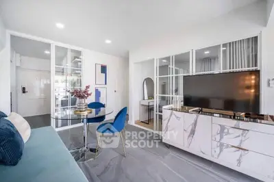 Modern living room with sleek marble TV stand and stylish blue chairs