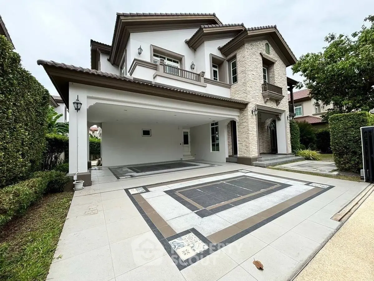 Elegant two-story house with spacious driveway and lush greenery