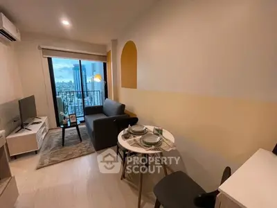 Modern living room with city view, cozy seating, and dining area in a stylish apartment.