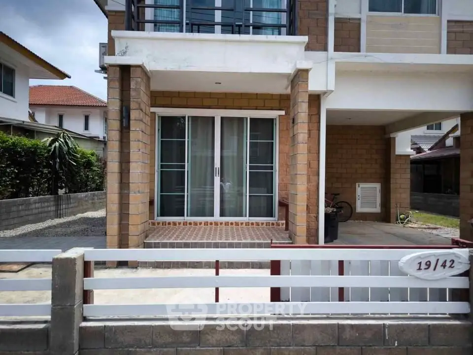 Charming two-story house with modern facade and spacious driveway in a serene neighborhood.