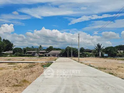 Expansive land plot with clear blue sky, ideal for development opportunities.