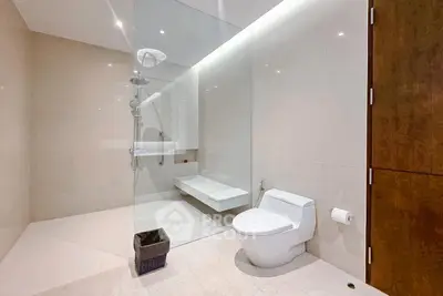 Modern bathroom with glass shower and sleek fixtures in luxury real estate property.