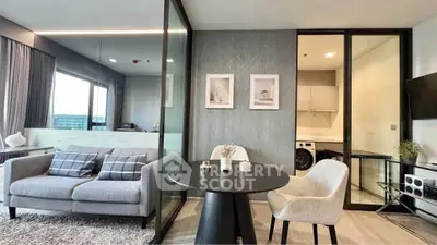 Modern living room with stylish decor and open kitchen layout in a contemporary apartment.