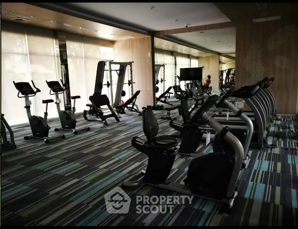 Modern gym with state-of-the-art fitness equipment and stylish interior design.