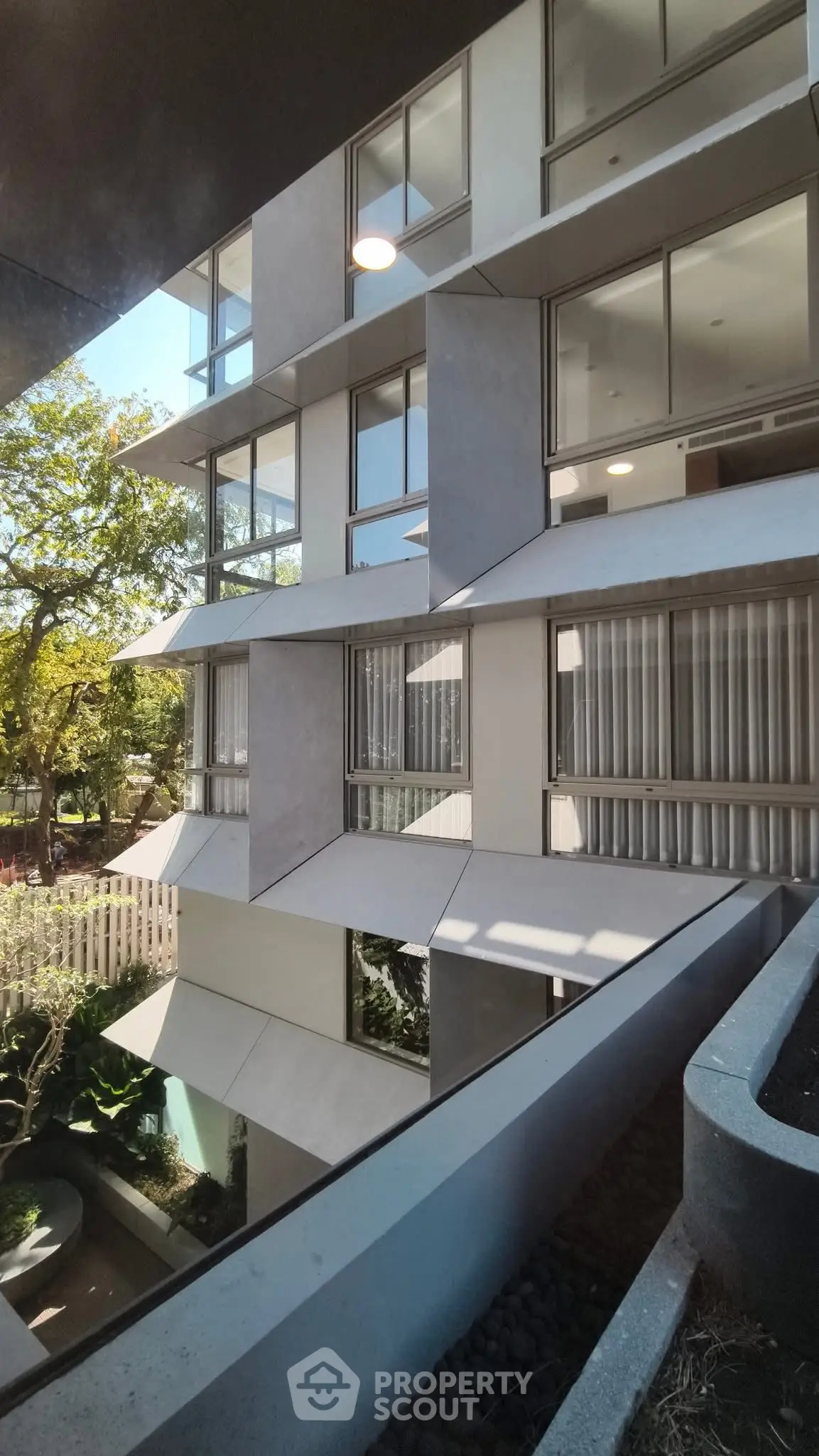 Modern architectural building with unique geometric facade and large windows