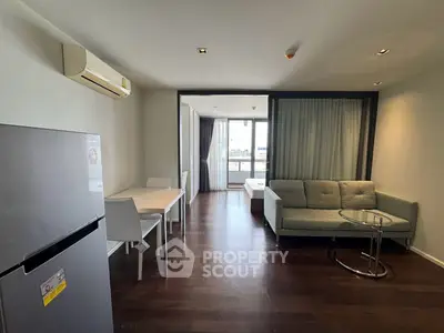 Modern living room with sleek furniture and balcony view in a stylish apartment.