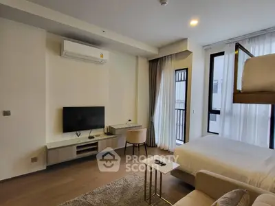 Modern bedroom with TV, air conditioning, and stylish decor in a cozy apartment.