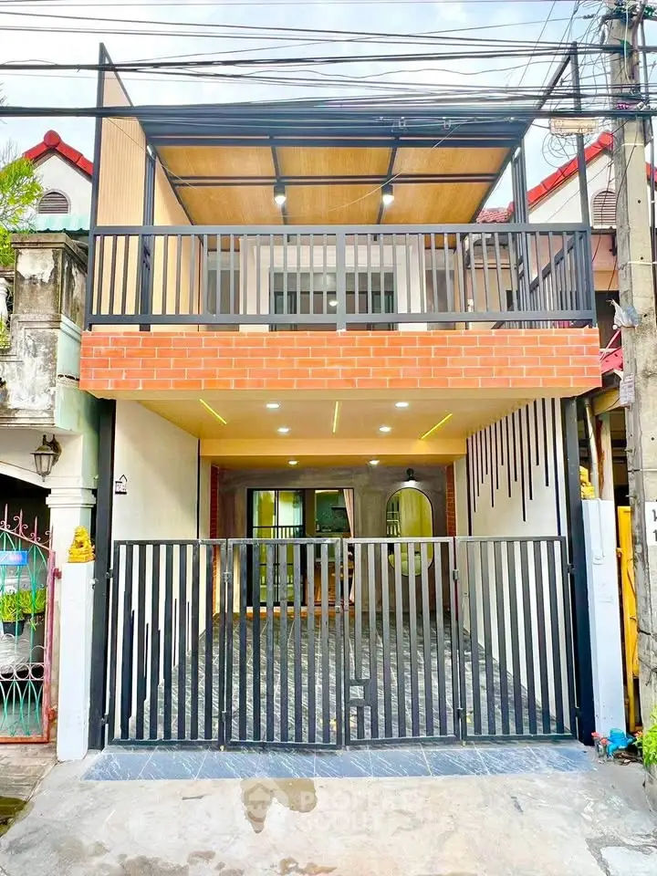 Modern two-story house with stylish balcony and gated entrance