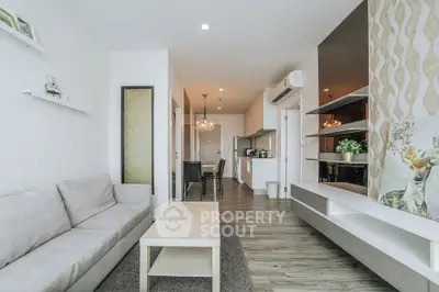 Modern living room with open kitchen, stylish decor, and cozy ambiance in a contemporary apartment.