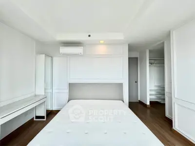 Spacious modern bedroom with minimalist design and ample natural light