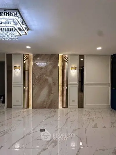 Luxurious modern interior with marble flooring and elegant lighting, perfect for upscale living.