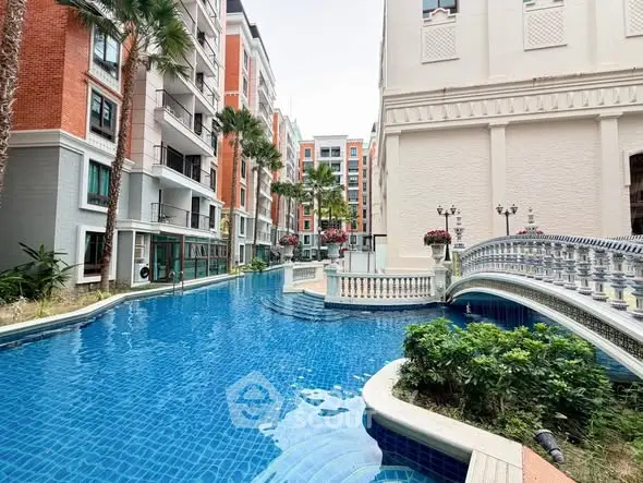 Luxurious residential complex with stunning pool and elegant architecture, perfect for modern living.