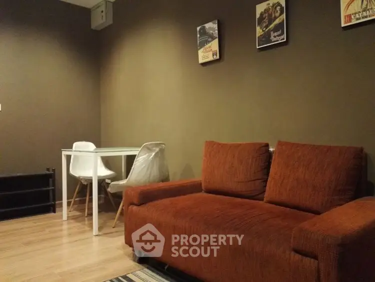 Cozy living room with brown sofa and modern dining set