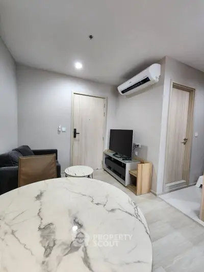 Modern living room with marble table and sleek furniture in a cozy apartment.