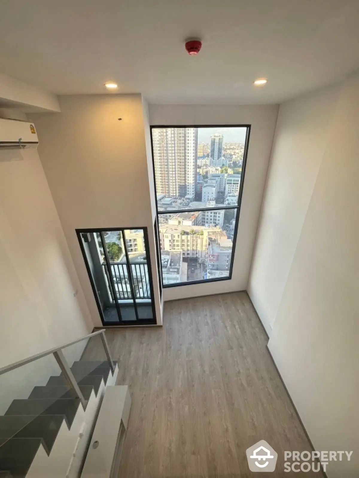 Modern loft apartment with high ceiling and city view from large window