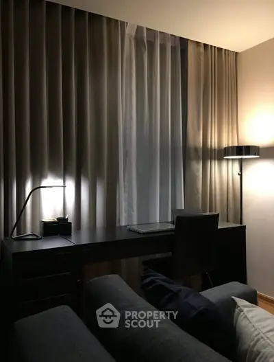 Elegant study area with modern desk and ambient lighting in a cozy apartment.