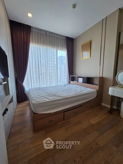 Modern bedroom with large window and wooden flooring in a high-rise apartment.