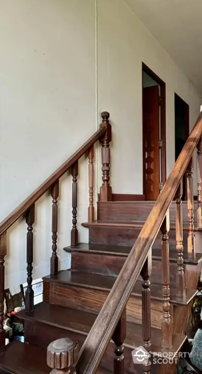 Elegant wooden staircase with classic banister in a cozy home interior