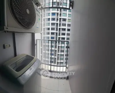 Compact balcony with washing machine and city view in modern apartment