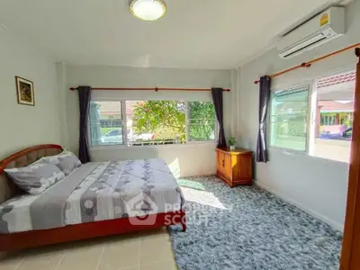 Bright and cozy bedroom with large windows and modern decor