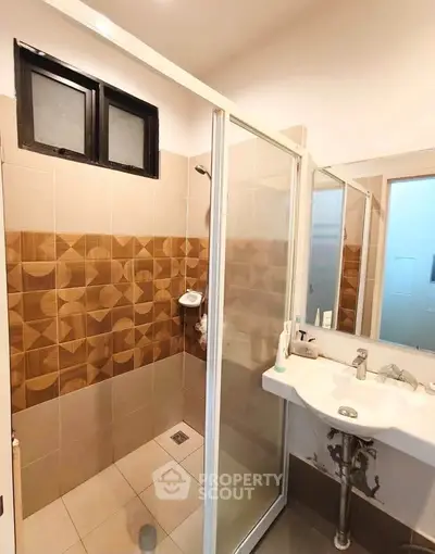 Modern bathroom with stylish tile design and glass shower enclosure